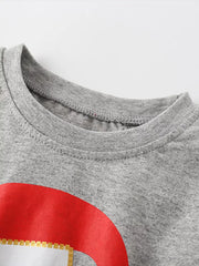 Gray baby pajama top with Santa graphic detail and ruffled puff sleeves.