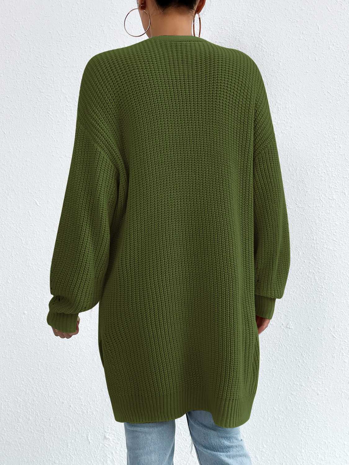 Longline knit open cardigan in green acrylic with ribbed texture and long sleeves.