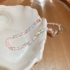 Pastel bead chain necklace with gold accents in pink, purple, and blue.
