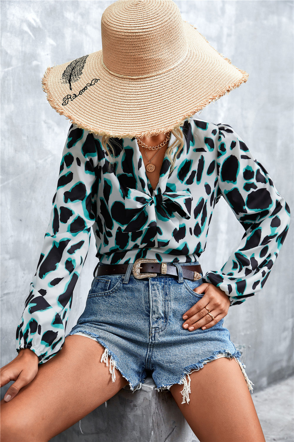 Abstract print pussy bow blouse with balloon sleeves in white, black and teal.