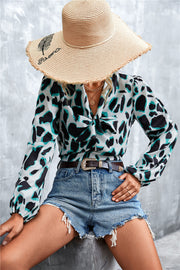 Abstract print pussy bow blouse with balloon sleeves in white, black and teal.