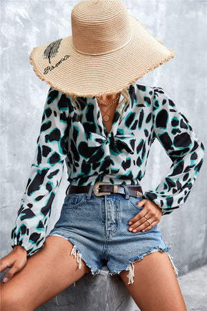Abstract print pussy bow blouse with balloon sleeves in white, black and teal.