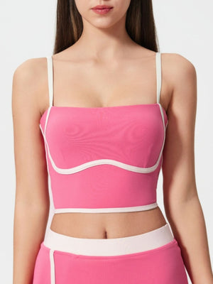 Fuchsia pink contour-trimmed crop top with white piping and sculpted bust detail.