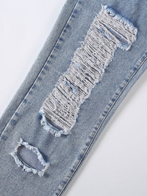 Light wash denim jeans with shredded knee detail and distressed rips.