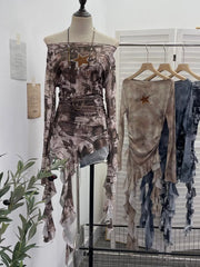 Asymmetrical ruffle hem t-shirt with graphic print and star detail, worn off-shoulder.