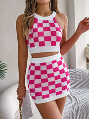 Checkerboard knit halter crop top and mini skirt set in hot pink and white.