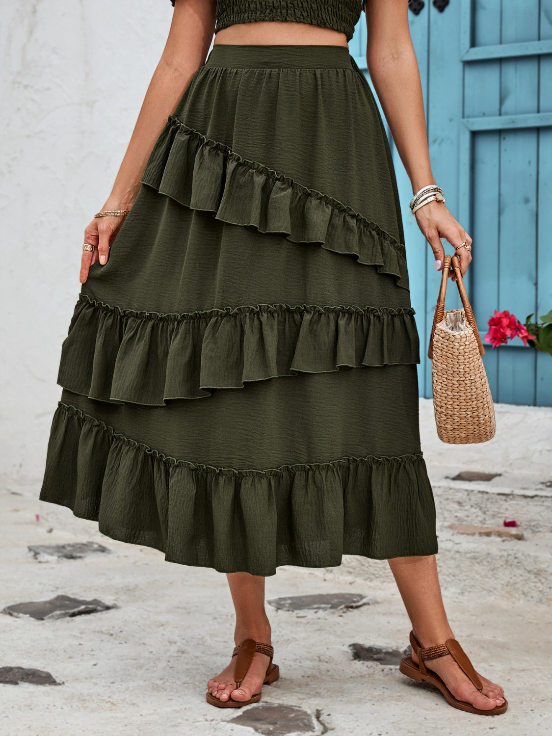Dark green midi skirt with tiered ruffles and textured fabric.