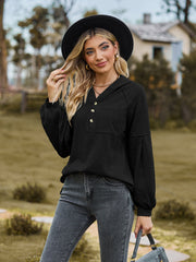 Black textured knit henley hoodie with balloon sleeves and button detail