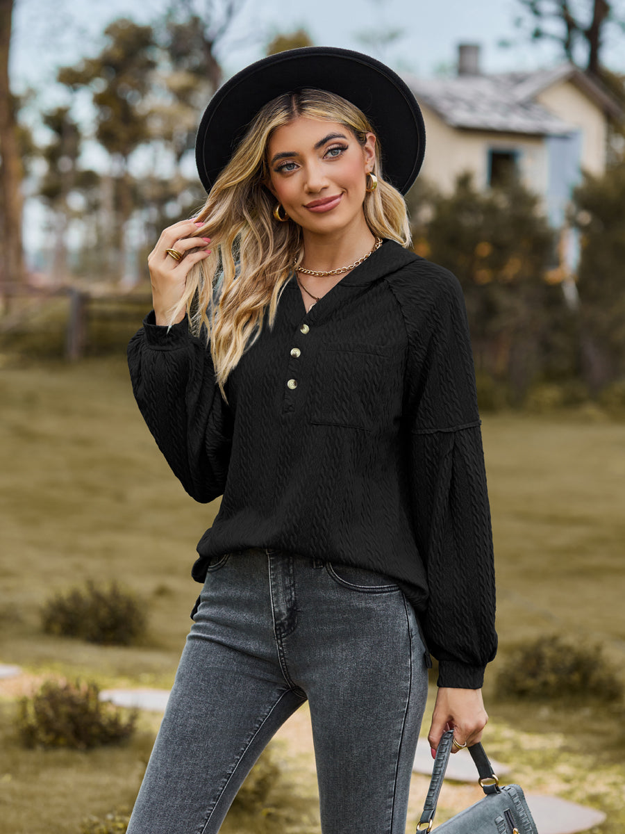 Black textured knit henley hoodie with balloon sleeves and button detail