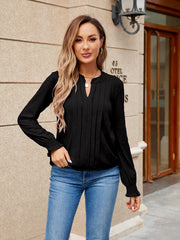 Black long sleeve blouse with V-neck, pintuck detail and ruffled cuffs.
