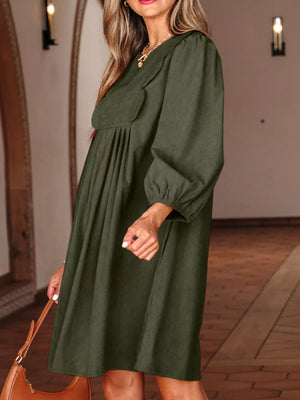 Green polyester mini dress with scalloped V-neck, balloon sleeves, and A-line cut.