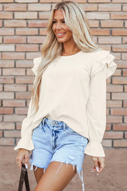 Textured ruffle sleeve blouse in eggshell with ruffled cuffs.