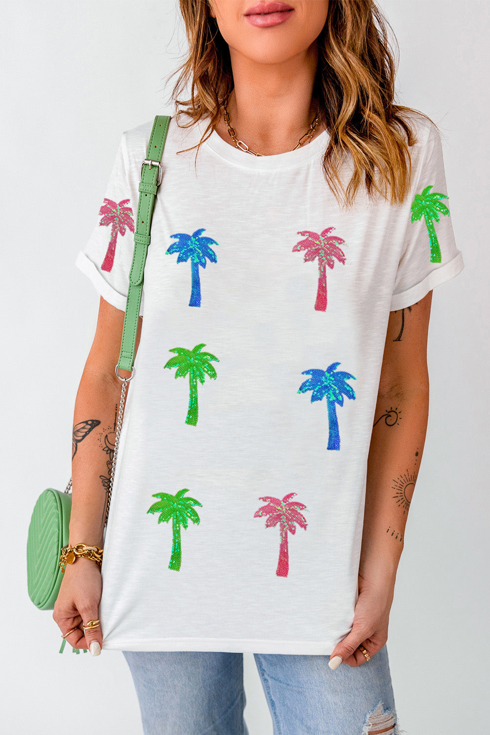 White crewneck tee with glitter palm tree print in pink, blue, and green.