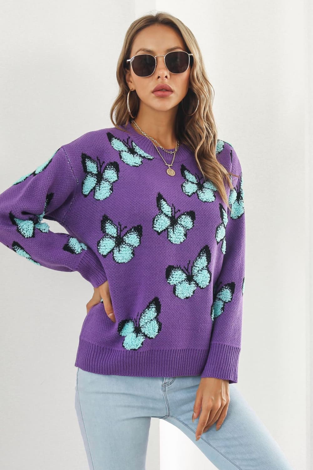 Purple knit crewneck pullover sweater with allover light blue butterfly motif