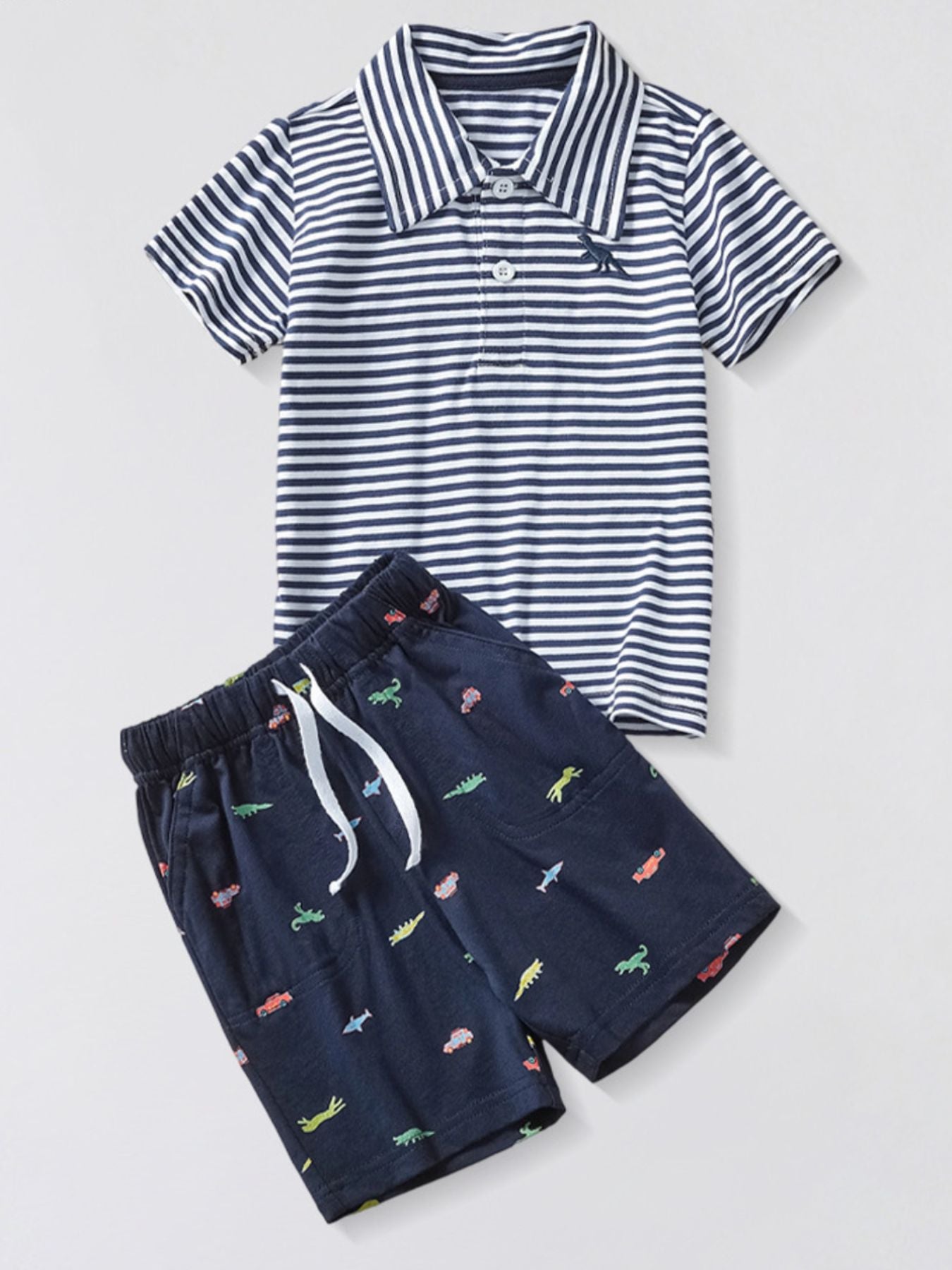 Toddler navy shorts with dinosaur and car print and striped polo shirt.