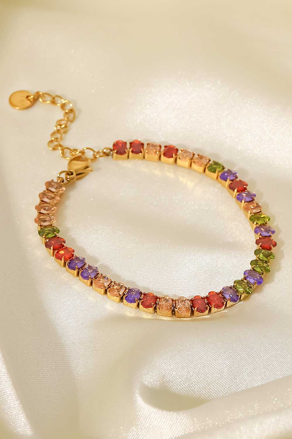 18K gold plated tennis bracelet with multi-colored zircon stones and adjustable clasp.