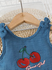 Blue peplum tank with cherry graphic and bow shoulder straps.