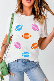 White t-shirt with rolled sleeves and scattered colorful football graphics.