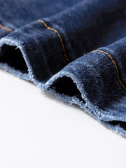 Patch pocket wide-leg jeans in medium wash denim with visible orange stitching and frayed hem detail.