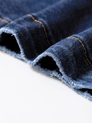 Patch pocket wide-leg jeans in medium wash denim with visible orange stitching and frayed hem detail.