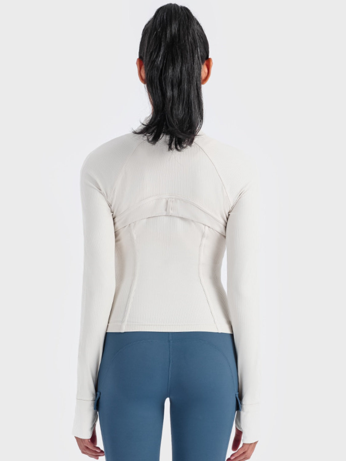 White ribbed performance zip-up track jacket with thumbholes and contoured back seams.