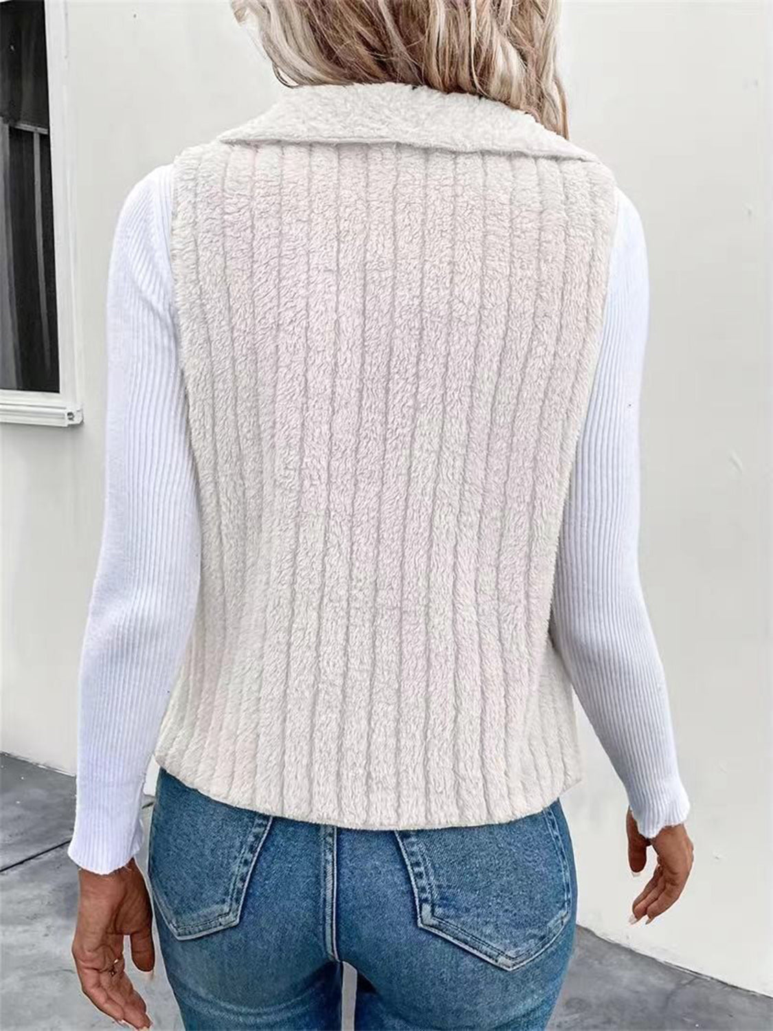 Textured teddy collarless vest in white with vertical ribbing detail.