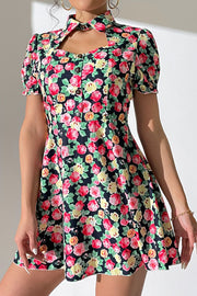 Floral mini dress with keyhole neckline, puff sleeves, and button front.