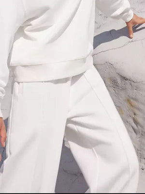 White seamed sweatshirt and wide-leg lounge pants set with visible stitching detail.