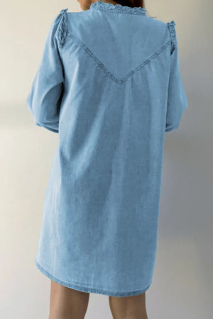 Light blue denim shirt dress with ruffled yoke and V-stitch detail.