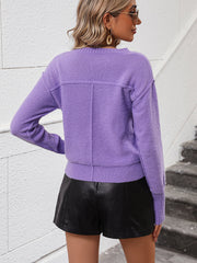 Lavender V-neck knit sweater with relaxed fit and seam detail on back.