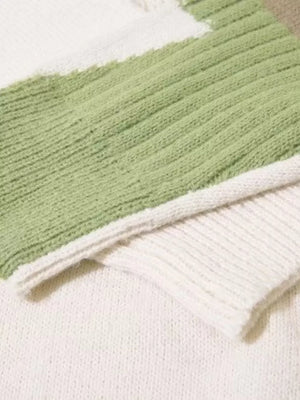 Contrast knit sweater in green and white with textured details and abstract color blocking.