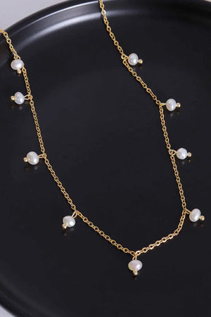 Gold chain necklace with dangling pearl accents
