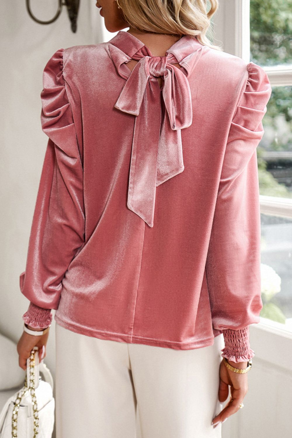 Dusty Pink velvet blouse with puff sleeves, smocked cuffs, and a back bow detail.