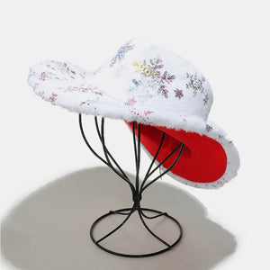 White faux fur cowboy hat with snowflake pattern and red lining.