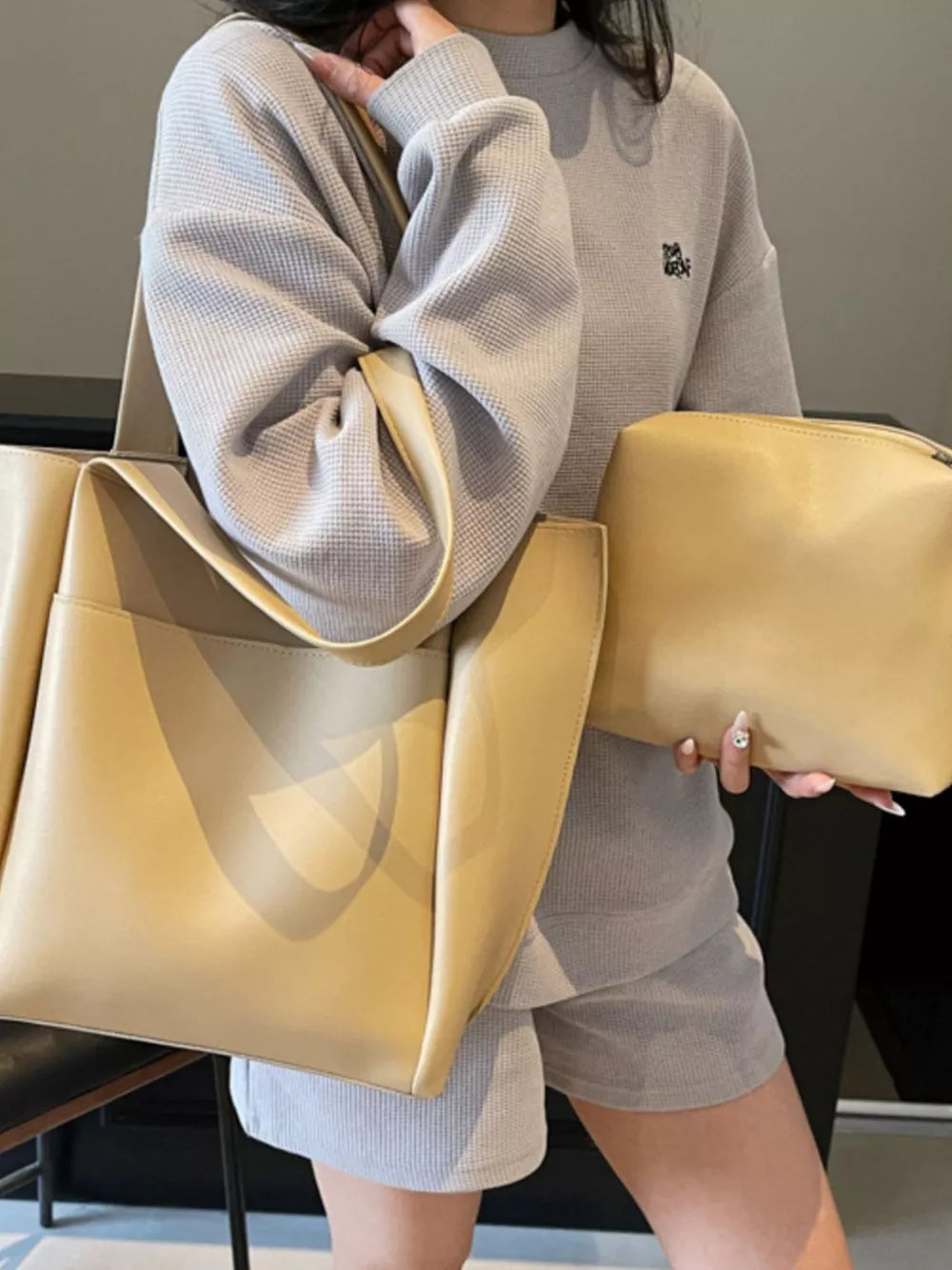 Khaki pu leather tote bag with matching pouch and shoulder strap detail.