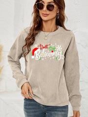 Beige corduroy crewneck sweatshirt with Christmas graphic and Santa hat detail.