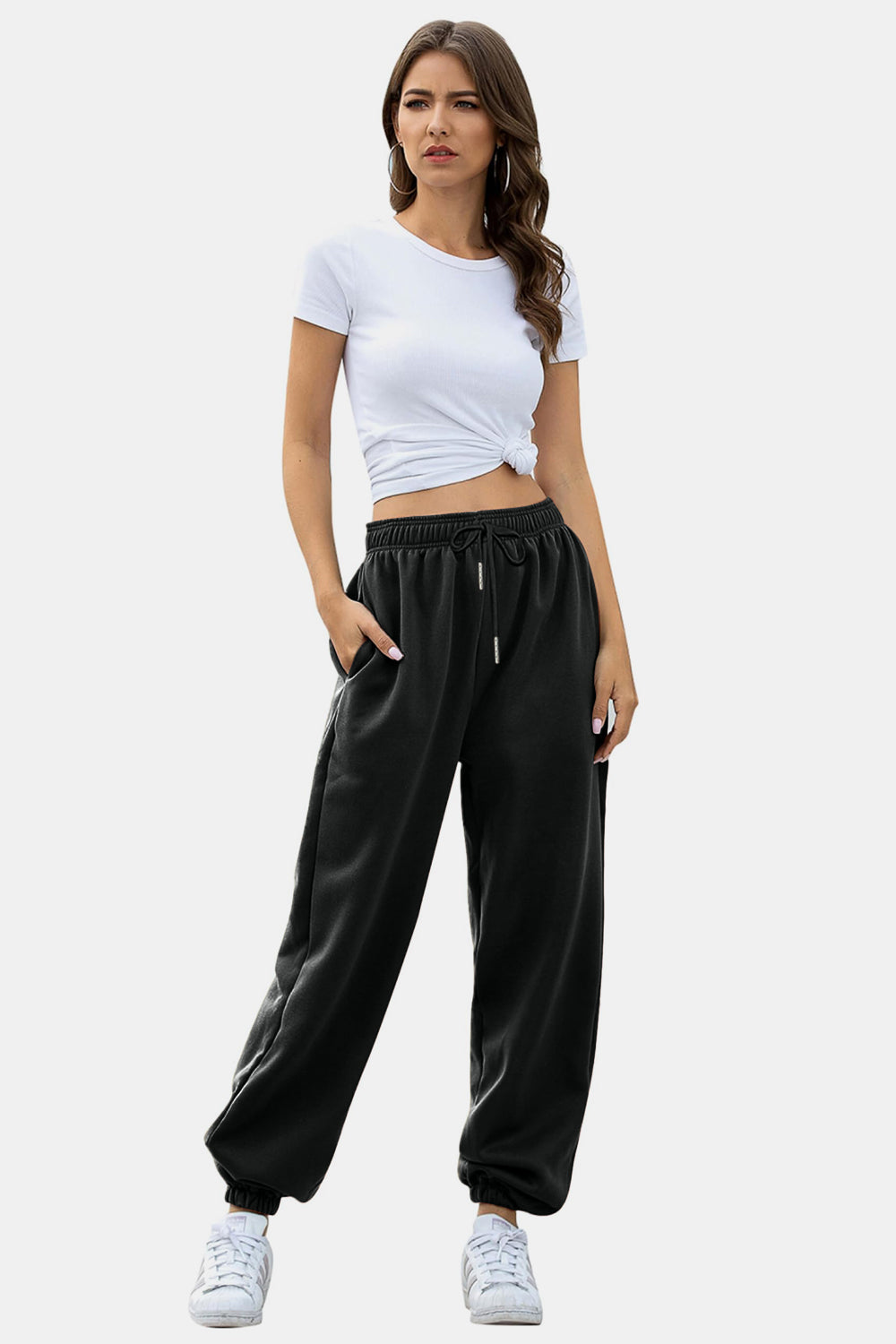 Black relaxed-fit cuffed sweatpants with drawstring waist and pockets.