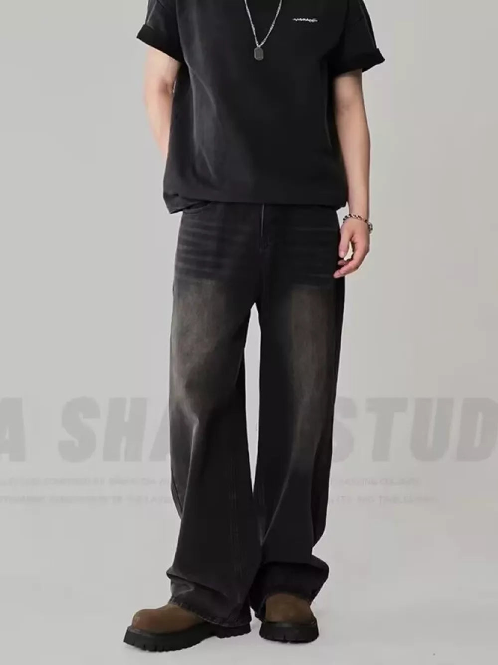 Oversized dark wash men's jeans in black gray with a relaxed fit.