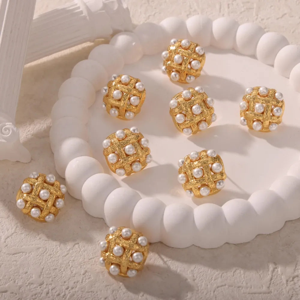Gold woven pearl grid earrings with a textured finish.