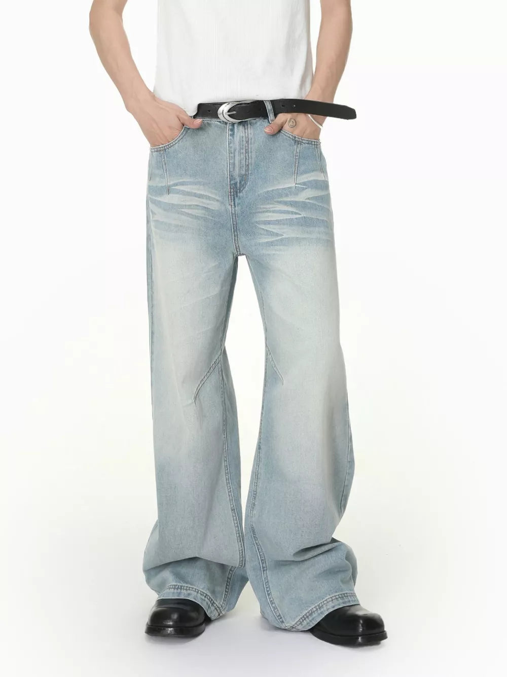 Men's light wash wide-leg jeans with vintage fade and relaxed fit.