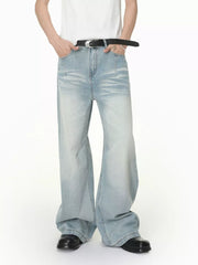 Men's light wash wide-leg jeans with vintage fade and relaxed fit.
