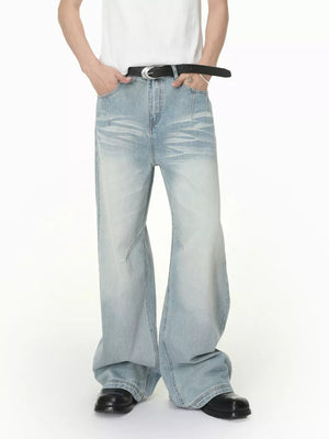 Men's light wash wide-leg jeans with vintage fade and relaxed fit.