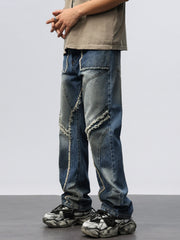 Men's wide leg jeans in blue denim with frayed hem details and paneling.