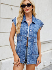 Denim leopard print sleeveless shacket in medium wash with button front and chest pockets.