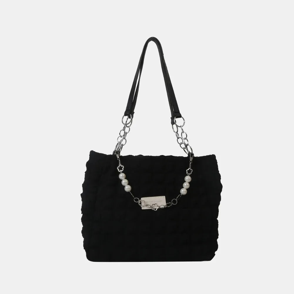 Black textured grid shopper bag with pearl and chain detail.