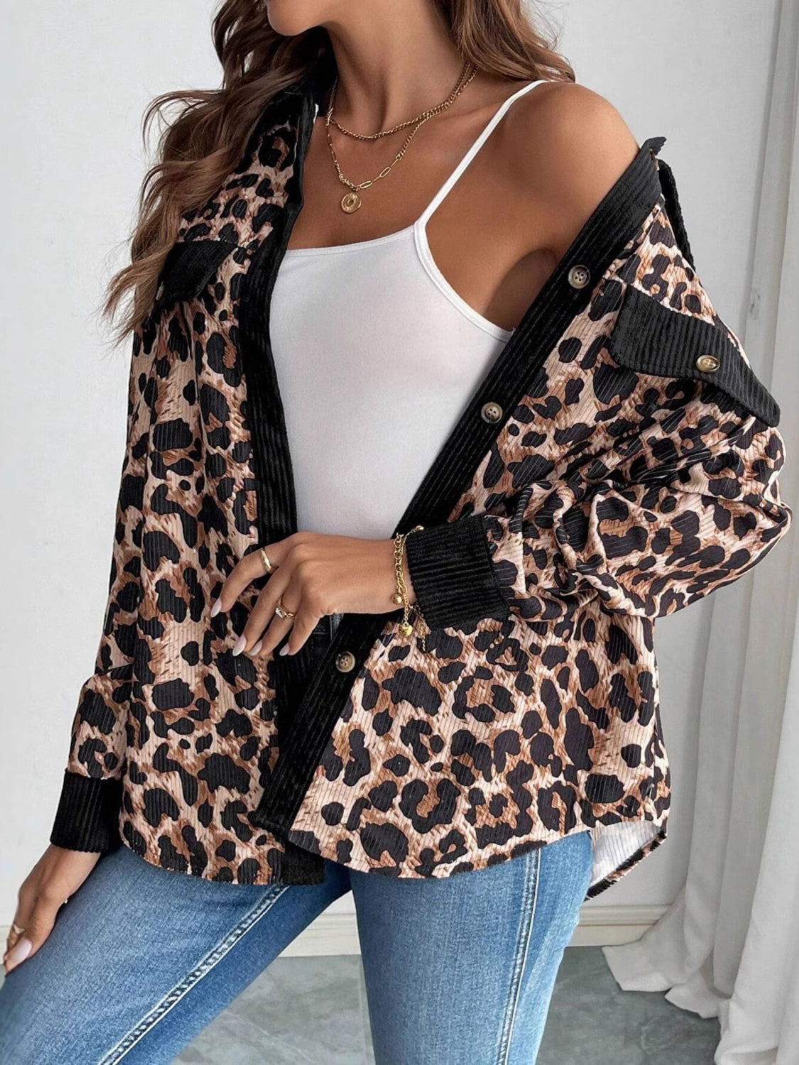 Leopard corduroy utility shirt jacket with black accents and button details.