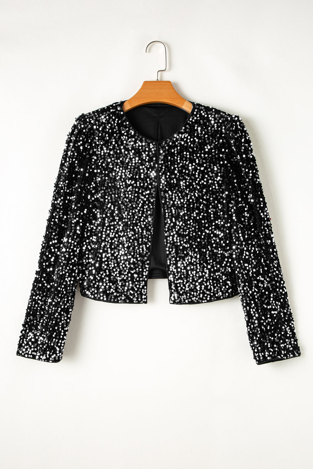 Black sequin embellished cropped open jacket with round neckline and long sleeves.