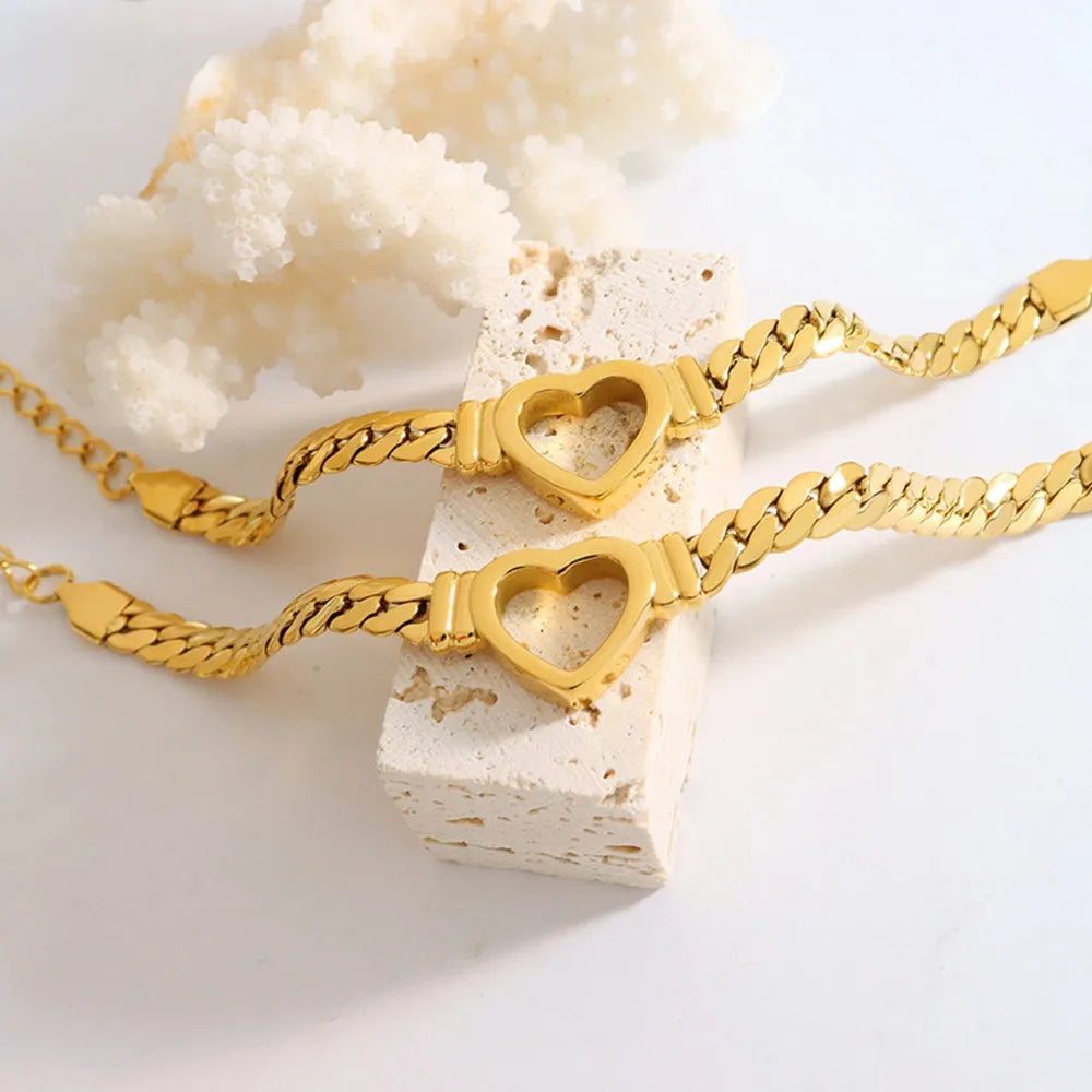 Gold curb chain bracelet with heart links
