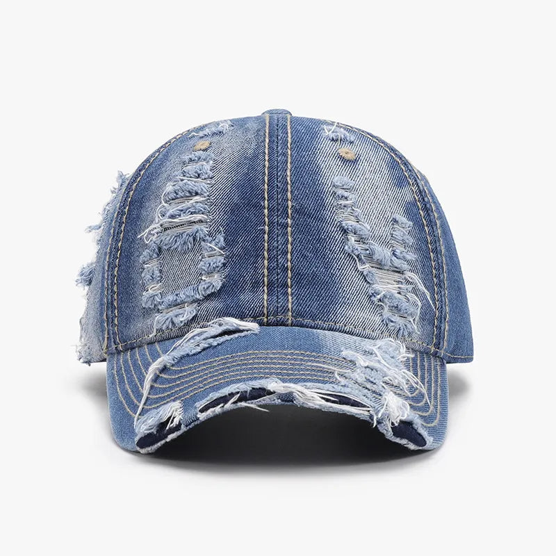 Ripped denim baseball cap in dark wash cotton with distressed details.
