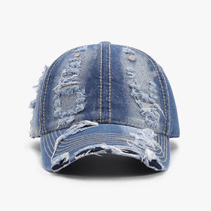 Ripped denim baseball cap in dark wash cotton with distressed details.
